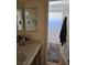 Bathroom featuring a vanity with double mirrors and a shower with a curtain at 8345 Mozley Park St, Las Vegas, NV 89113