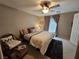 Comfortable bedroom featuring a ceiling fan, plush rug, and neutral decor for relaxation at 8345 Mozley Park St, Las Vegas, NV 89113