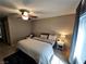 Neutral toned bedroom featuring a ceiling fan, natural light, and calm ambiance at 8345 Mozley Park St, Las Vegas, NV 89113
