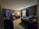 View of a bedroom featuring a bed, TV, dresser, and window with natural light at 8345 Mozley Park St, Las Vegas, NV 89113