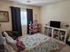 Colorful bedroom with a decorated bed, play area with toys, and a window providing natural light at 8345 Mozley Park St, Las Vegas, NV 89113