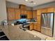 Kitchen with stainless steel appliances, granite counters, and oak cabinets at 8345 Mozley Park St, Las Vegas, NV 89113