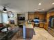 View of kitchen, breakfast bar, stainless steel appliances and open view to living room at 8345 Mozley Park St, Las Vegas, NV 89113