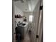 Bright laundry room featuring a modern washer and dryer and ample shelving space at 8345 Mozley Park St, Las Vegas, NV 89113