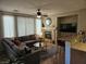 Spacious living room features a cozy fireplace, media center and a comfortable sectional sofa at 8345 Mozley Park St, Las Vegas, NV 89113