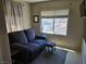 Relaxing living room with comfortable seating, window, and calm ambiance at 8345 Mozley Park St, Las Vegas, NV 89113