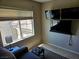 Relaxing living room featuring mounted TV's, window, and comfortable seating at 8345 Mozley Park St, Las Vegas, NV 89113