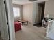 Living room area with cozy red sofa, wood coffee table, and ample natural light at 8345 Mozley Park St, Las Vegas, NV 89113