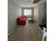 Living room area with cozy red sofa, wood coffee table, and ample natural light at 8345 Mozley Park St, Las Vegas, NV 89113