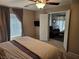 Comfortable main bedroom with a ceiling fan, neutral walls, and an ensuite seating area for relaxing at 8345 Mozley Park St, Las Vegas, NV 89113
