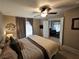 Comfortable main bedroom featuring a ceiling fan, ensuite access, and natural light from a window at 8345 Mozley Park St, Las Vegas, NV 89113