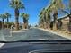 Street view lined with palm trees and well-maintained homes in a desert community at 8345 Mozley Park St, Las Vegas, NV 89113