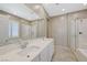 Bright bathroom features dual sinks and a glass shower at 8562 Insignia Ave # 102, Las Vegas, NV 89178
