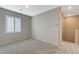 Upstairs bedroom with neutral carpet and light gray walls at 8562 Insignia Ave # 102, Las Vegas, NV 89178