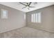 Neutral bedroom offers a ceiling fan and plush carpet at 8562 Insignia Ave # 102, Las Vegas, NV 89178