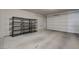 Spacious garage with concrete floors and shelving units at 8562 Insignia Ave # 102, Las Vegas, NV 89178