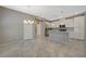 Open-concept kitchen featuring white cabinets, granite countertops, and stainless steel appliances at 8562 Insignia Ave # 102, Las Vegas, NV 89178