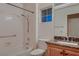 Bright bathroom features a tub and shower combo and granite countertop sink at 8613 Linderwood Dr, Las Vegas, NV 89134