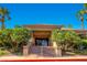 Community clubhouse entrance with palm trees and well-manicured landscape offers a welcoming and luxurious atmosphere at 8613 Linderwood Dr, Las Vegas, NV 89134