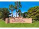 A picturesque sign for Palm Valley Golf Club surrounded by lush landscaping and towering palm trees at 8613 Linderwood Dr, Las Vegas, NV 89134