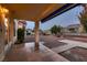 Relaxing covered patio extends living space outdoors, complemented by serene landscaping and tranquil desert surroundings at 8613 Linderwood Dr, Las Vegas, NV 89134