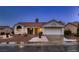 Charming single-story home boasts a red tile roof, two-car garage, and desert landscaping at 8613 Linderwood Dr, Las Vegas, NV 89134