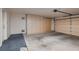 This large garage features blue carpeting, cabinets for storage, and both an automatic and manual door at 8613 Linderwood Dr, Las Vegas, NV 89134