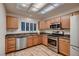 Well-lit kitchen featuring stainless steel appliances, ample counter space, and warm wood cabinetry at 8613 Linderwood Dr, Las Vegas, NV 89134