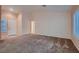 Bright, open-concept living room with plush carpeting and ample natural light at 8613 Linderwood Dr, Las Vegas, NV 89134