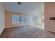 Spacious living room with a combination of plush carpet and wood flooring with natural light at 8613 Linderwood Dr, Las Vegas, NV 89134