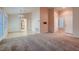 Open-concept living area combining carpet and wood floors, seamlessly connecting to the kitchen at 8613 Linderwood Dr, Las Vegas, NV 89134