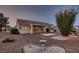The home's rear exterior with desert landscaping, a covered patio, and a red tile roof, for relaxed outdoor living at 8613 Linderwood Dr, Las Vegas, NV 89134