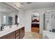 The bathroom features dual sinks, a glass shower, and an archway leading to the main bedroom at 9065 W Torino Ave, Las Vegas, NV 89148