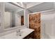 Bathroom featuring a vanity, mirror, sink, and a shower with decorative sliding doors at 9065 W Torino Ave, Las Vegas, NV 89148