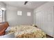 Serene bedroom featuring a comfortable bed, decorative windows, and closet space at 9065 W Torino Ave, Las Vegas, NV 89148