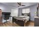 This bedroom features hard wood floors, a ceiling fan, double closet, and a comfortable desk at 9065 W Torino Ave, Las Vegas, NV 89148