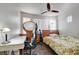 Bedroom featuring a ceiling fan, window, desk, vanity table with mirror, and a floral bed spread at 9065 W Torino Ave, Las Vegas, NV 89148