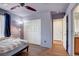 This bedroom features hardwood floors, neutral walls, a ceiling fan, and ample closet space at 9065 W Torino Ave, Las Vegas, NV 89148
