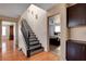 Staircase leading to bedrooms; a well-lit hallway with warm wood flooring at 9065 W Torino Ave, Las Vegas, NV 89148