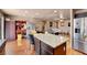 Open-concept kitchen with granite island, stainless steel fridge, and seamless flow to the living area at 9065 W Torino Ave, Las Vegas, NV 89148