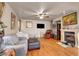 Spacious living room featuring a fireplace, hardwood floors, and a ceiling fan for a cozy environment at 9065 W Torino Ave, Las Vegas, NV 89148