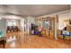 Open-concept living room with hardwood floors, arched doorways, and access to dining area at 9065 W Torino Ave, Las Vegas, NV 89148