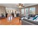 Upstairs living room featuring hardwood floors, a sofa, ceiling fan, and windows for natural light at 9065 W Torino Ave, Las Vegas, NV 89148