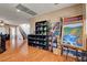 Open-concept living room featuring hardwood floors and a decorative shelving unit, perfect for showcasing art at 9065 W Torino Ave, Las Vegas, NV 89148