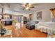 Bright living room features a ceiling fan and hardwood floors offers seamless flow to the kitchen and dining area at 9065 W Torino Ave, Las Vegas, NV 89148