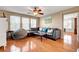 Living room featuring a sectional sofa, hardwood floors, many windows, and a ceiling fan at 9065 W Torino Ave, Las Vegas, NV 89148