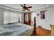 This main bedroom features hardwood floors, an armoire, and a large window, offering a cozy retreat at 9065 W Torino Ave, Las Vegas, NV 89148