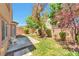 Private backyard featuring grass, mature trees, a patio, and block wall for outdoor entertaining at 9324 Freedom Heights Ave, Las Vegas, NV 89149