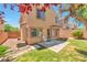 View of the backyard with a small lawn, patio, and desert landscaping, perfect for outdoor enjoyment at 9324 Freedom Heights Ave, Las Vegas, NV 89149
