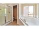 Bright bathroom featuring a soaking tub and separate shower at 9324 Freedom Heights Ave, Las Vegas, NV 89149